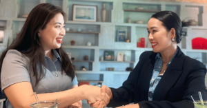 a woman shaking hands with another woman